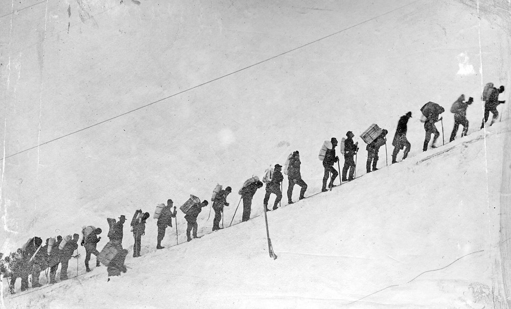 Gold miners climbing the Chilkoot Pass in Canada to Klondike.