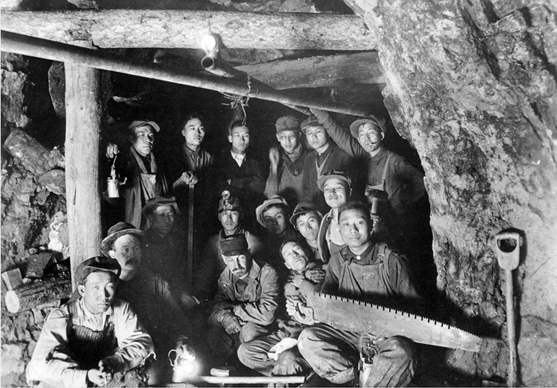Dr. James Underhill poses with Chinese-American miners (probably) in the Colorado School of Mines' Edgar Experimental Mine near Idaho Springs (Clear Creek County), Colorado, between 1920 and 1930.